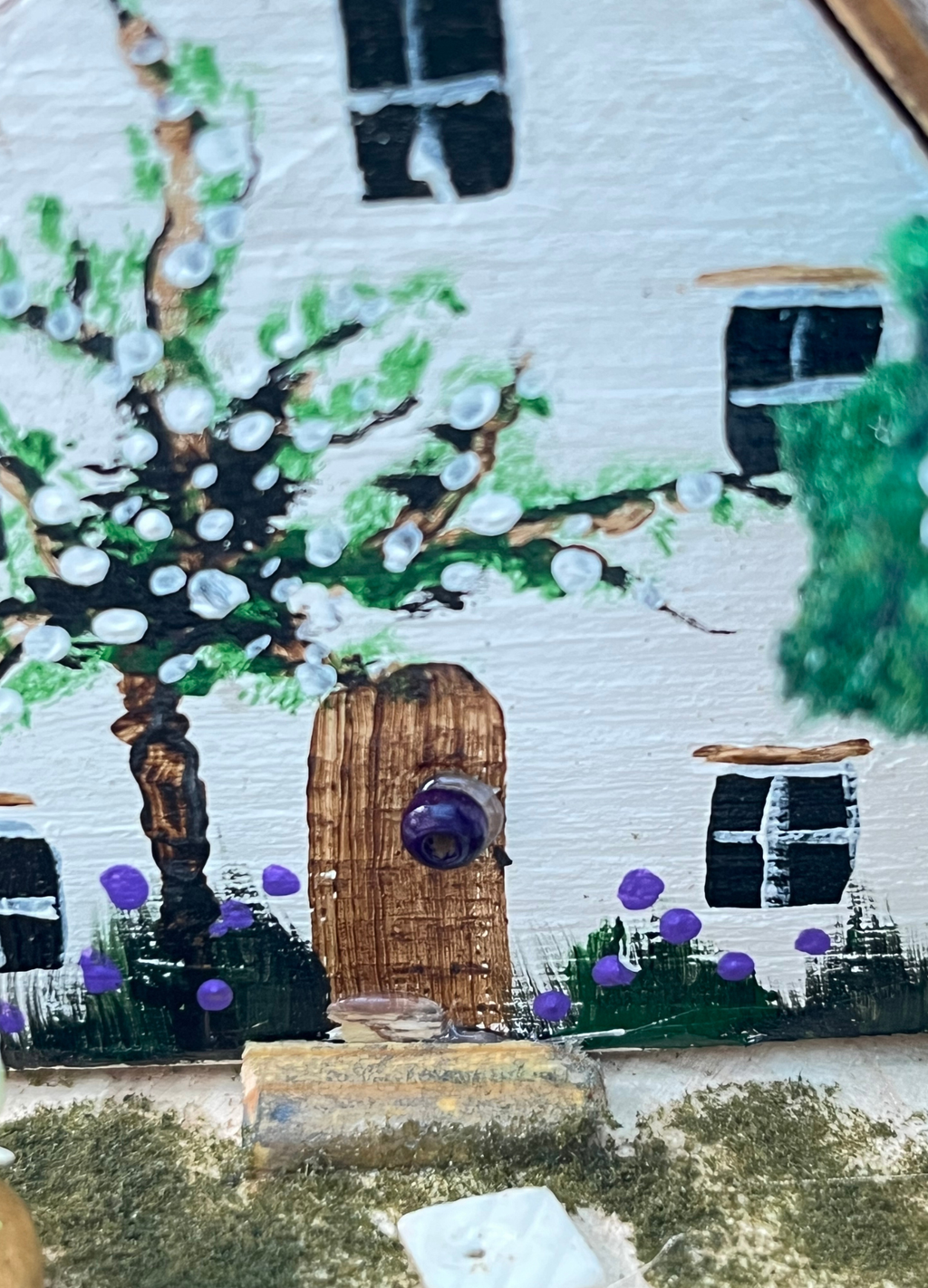 Miniature diorama with a house, and plants on a white background (RRH1041)