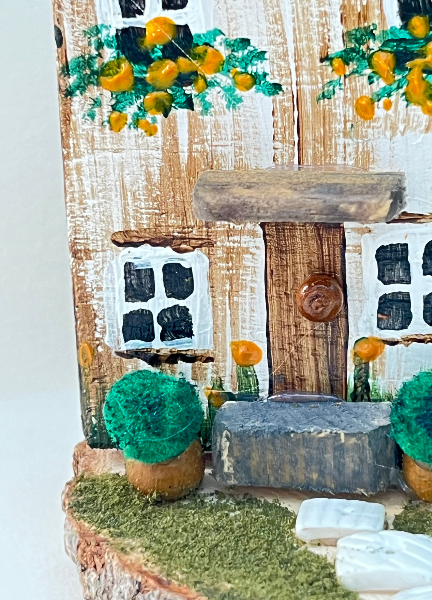 Miniature diorama with a house, and plants on a white background (RRH1045)