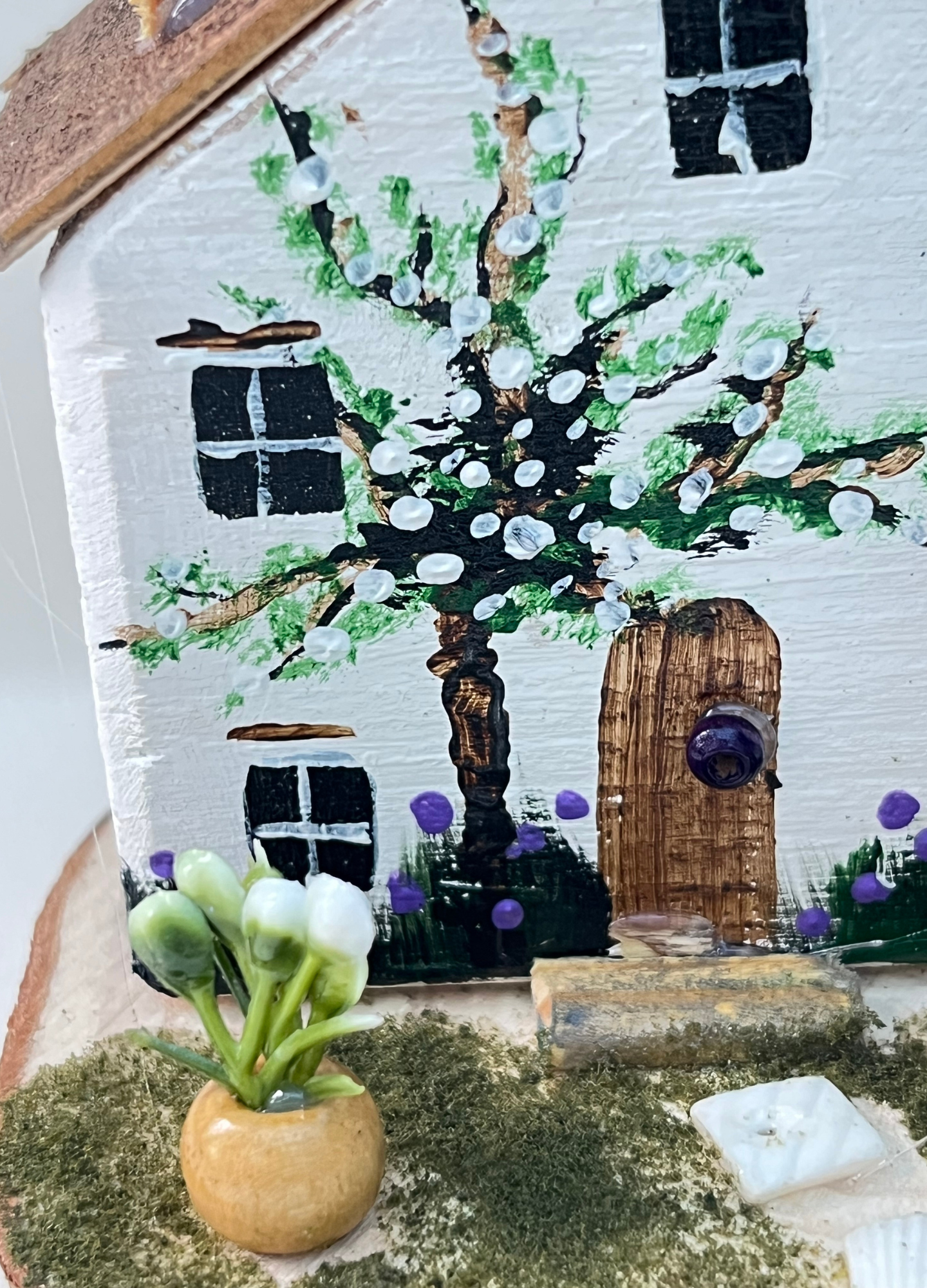 Miniature diorama with a house, and plants on a white background (RRH1041)