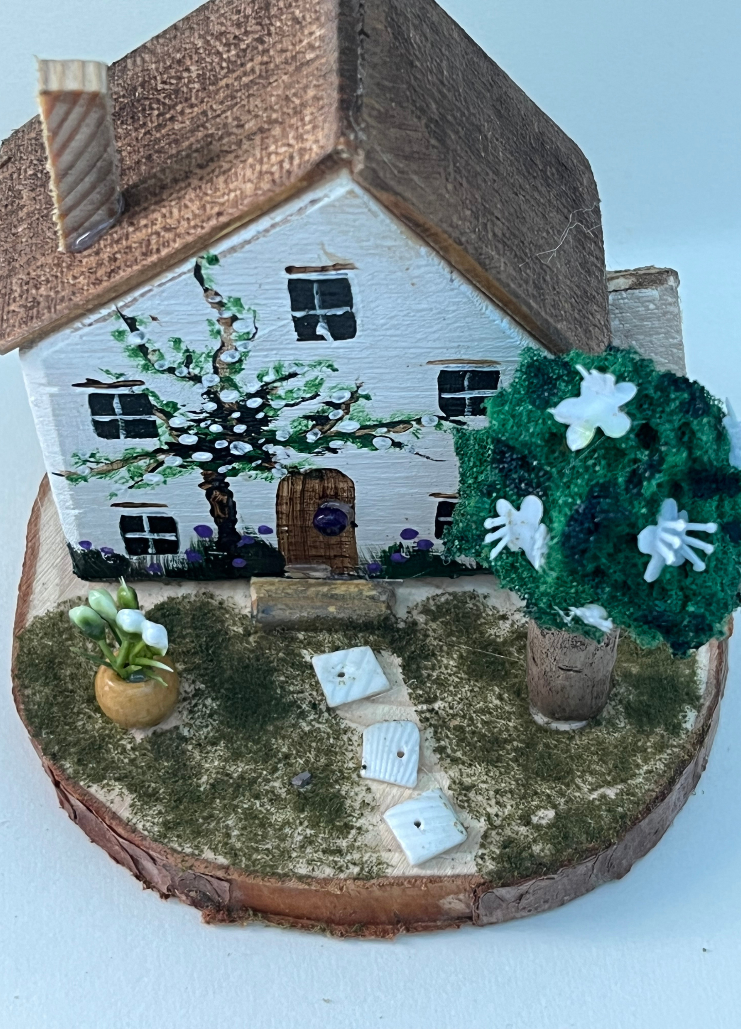 Miniature diorama with a house, and plants on a white background (RRH1041)