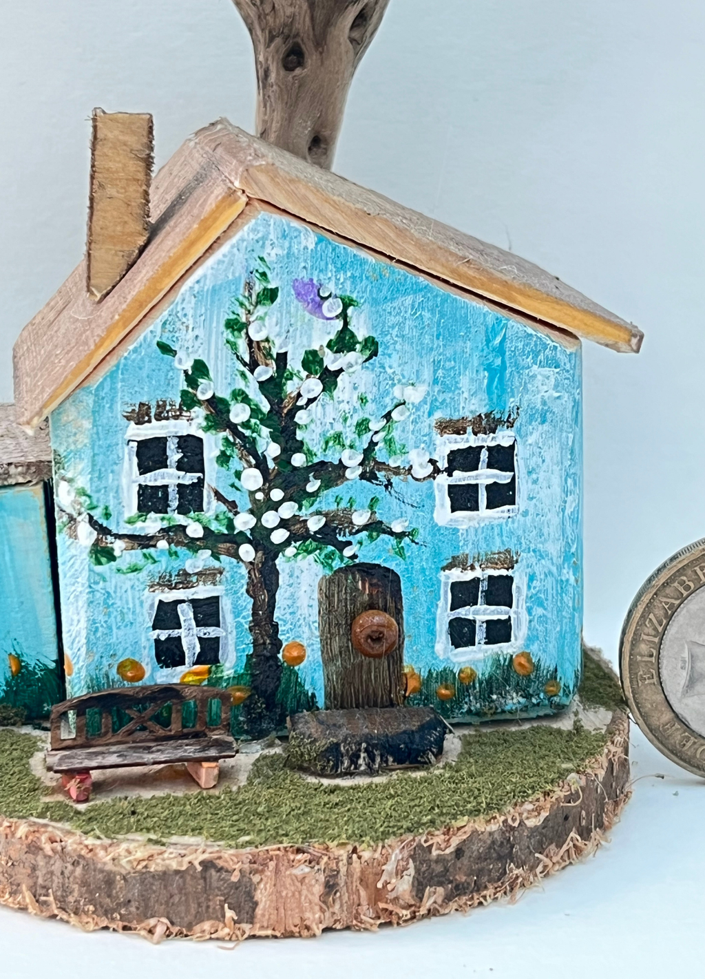 Miniature diorama with a house, and plants on a white background (RRH1042)