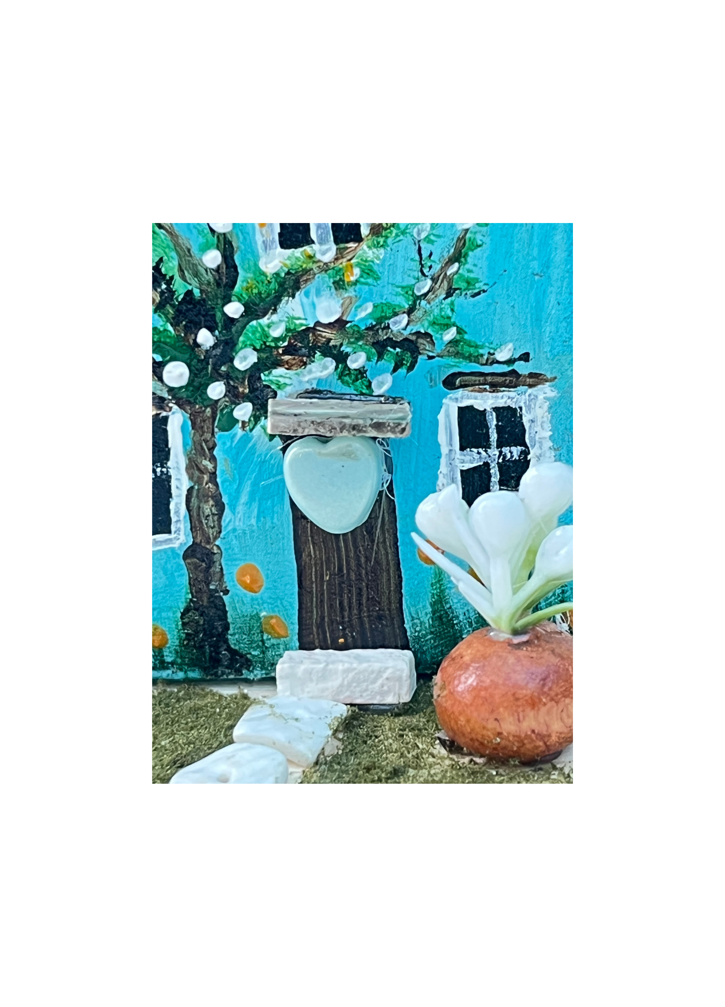 Miniature diorama with a house, and plants on a white background (RRH1046)
