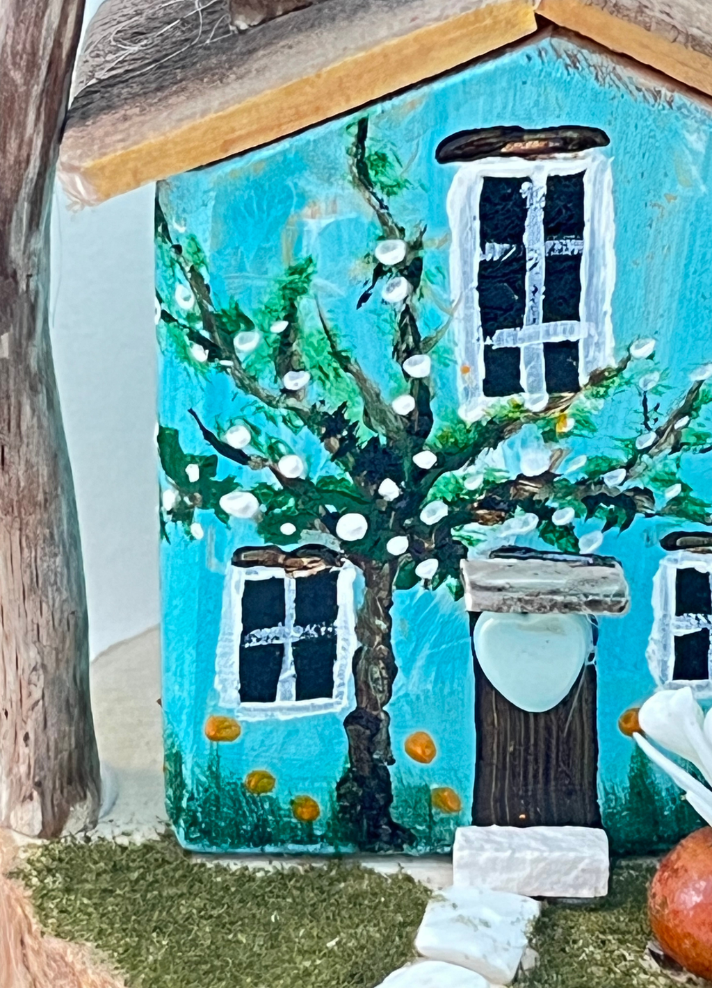 Miniature diorama with a house, and plants on a white background (RRH1046)