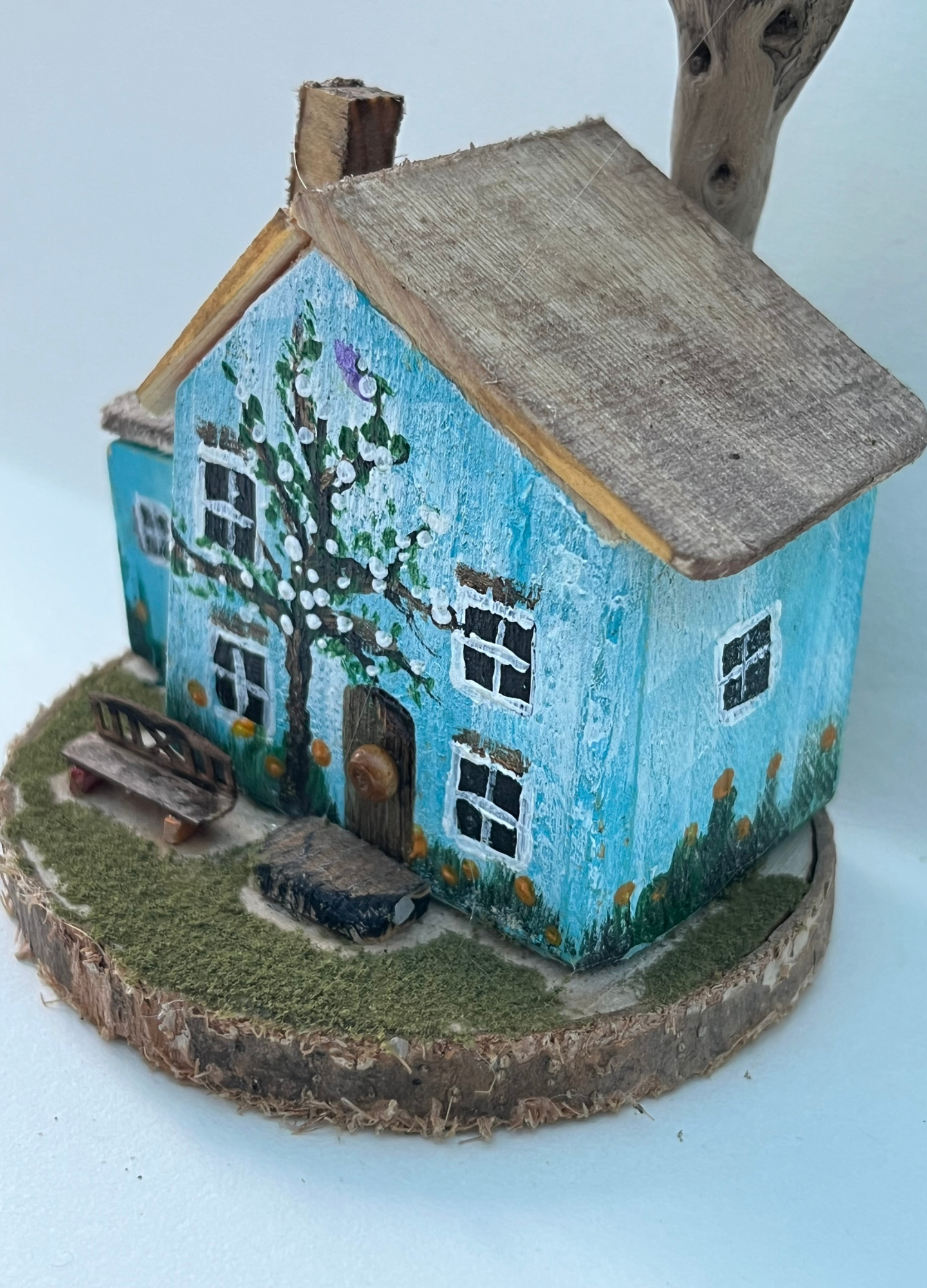 Miniature diorama with a house, and plants on a white background (RRH1042)