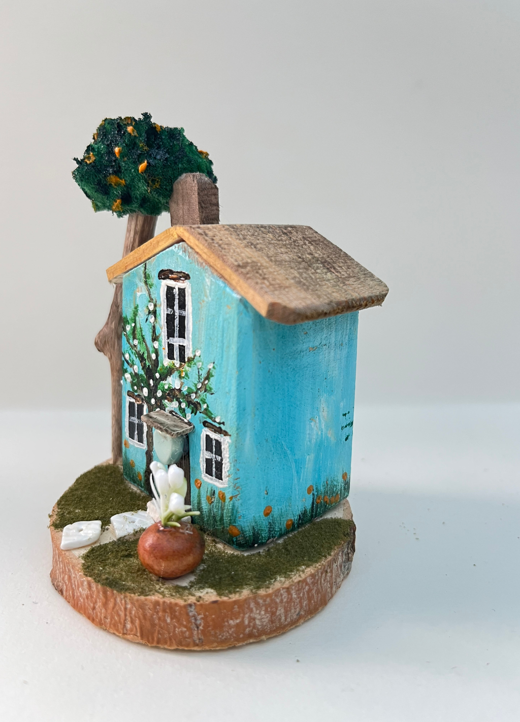 Miniature diorama with a house, and plants on a white background (RRH1046)