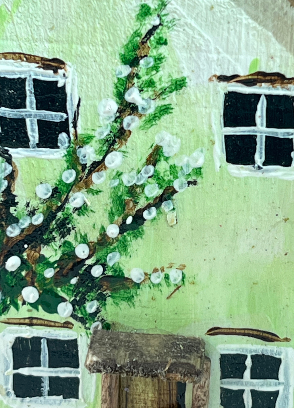 Miniature diorama with a house, and plants on a white background (RRH1049