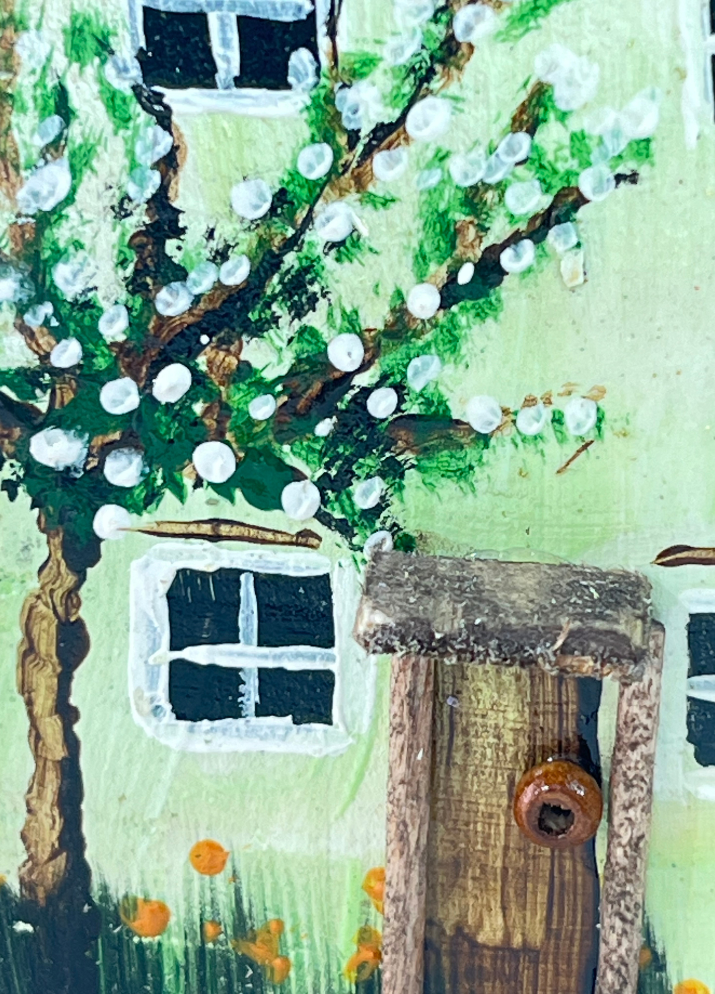 Miniature diorama with a house, and plants on a white background (RRH1049