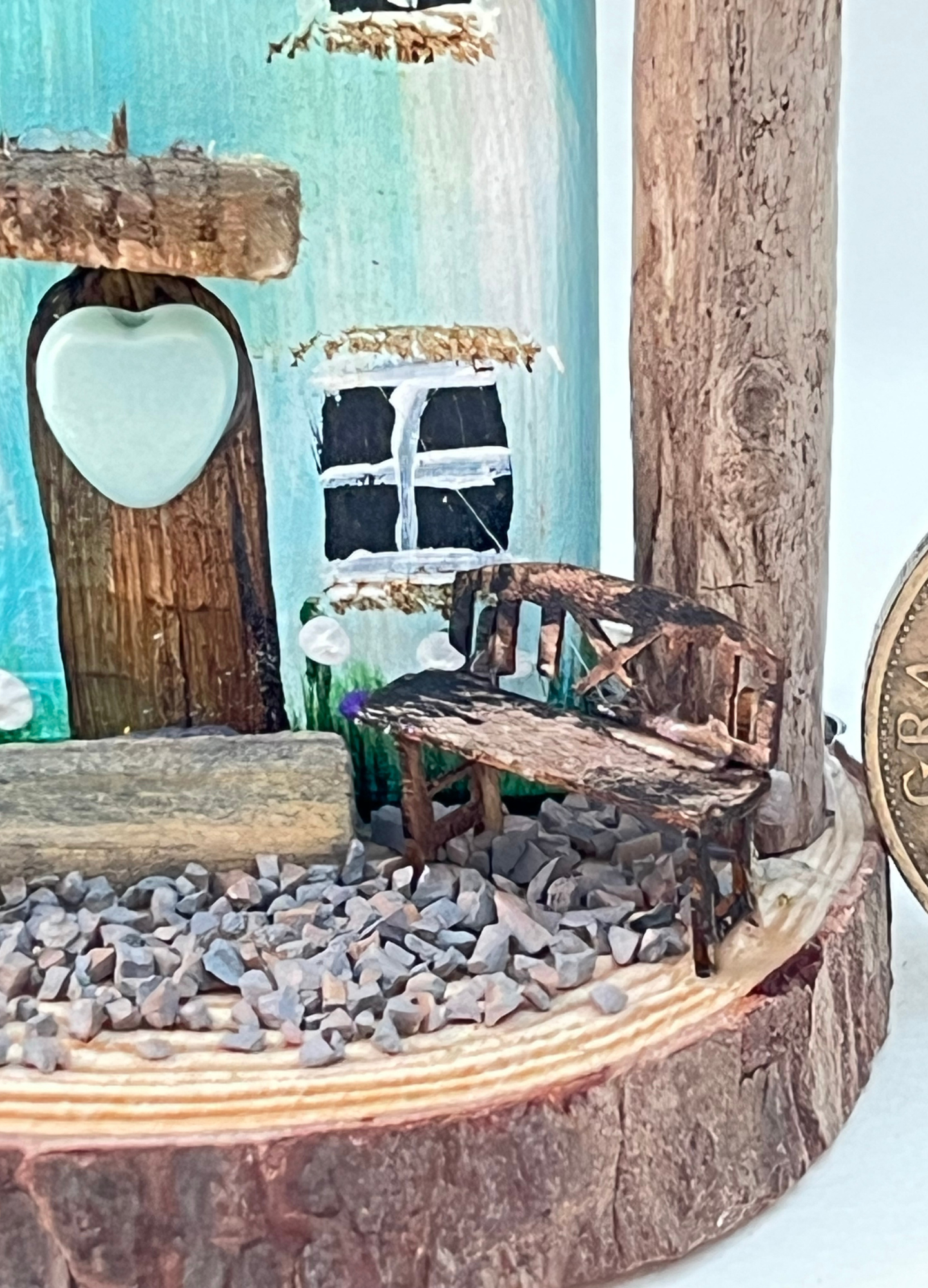 Miniature diorama with a house, and plants on a white background (RRH1047)