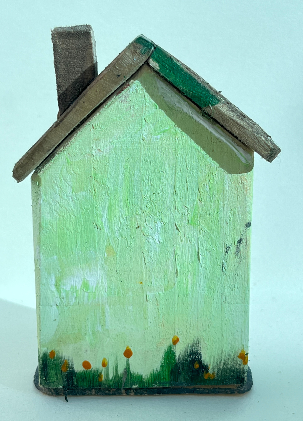 Miniature diorama with a house, and plants on a white background (RRH1049