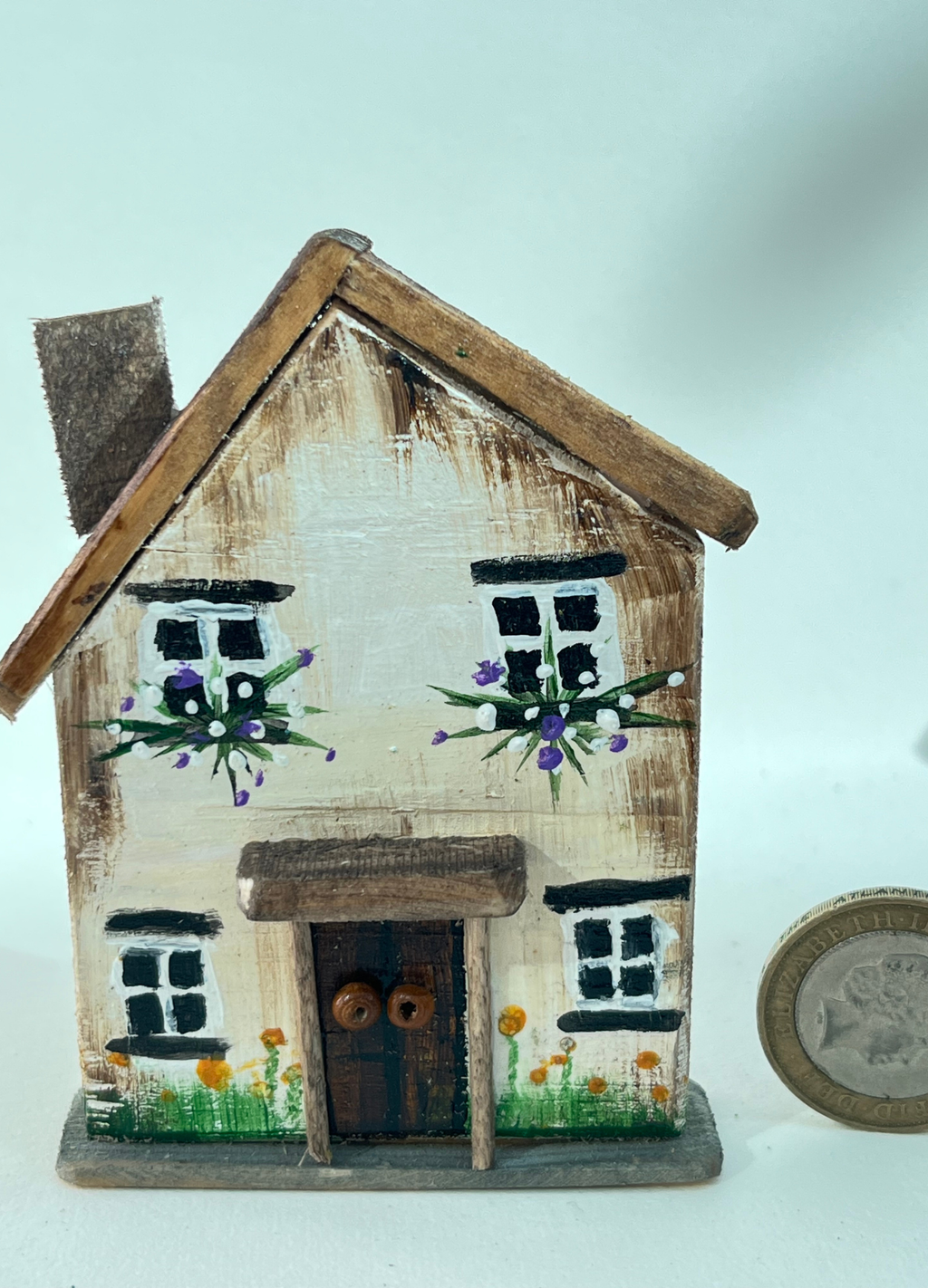 Miniature diorama with a house, and plants on a white background (RRH1050)