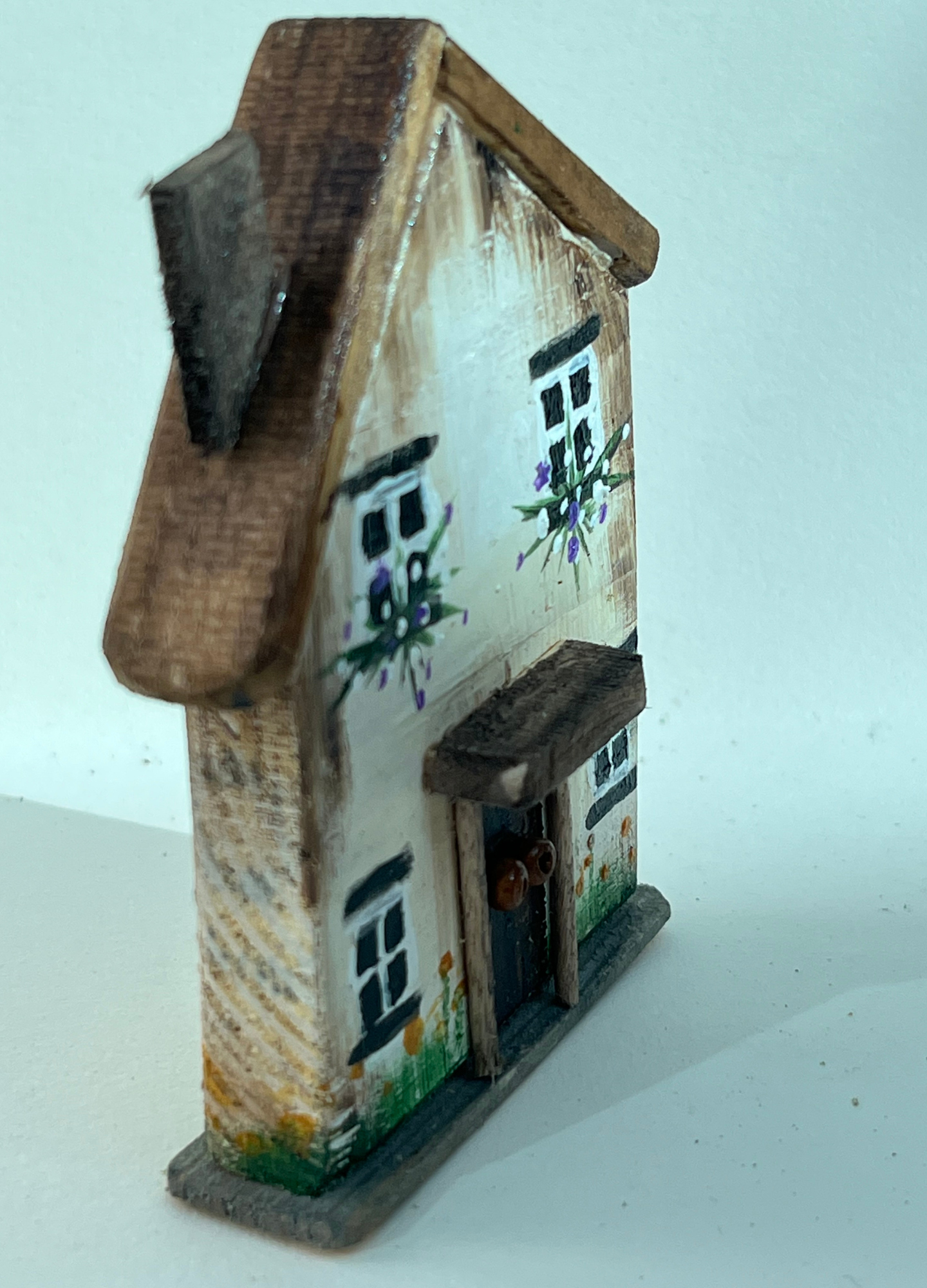 Miniature diorama with a house, and plants on a white background (RRH1050)