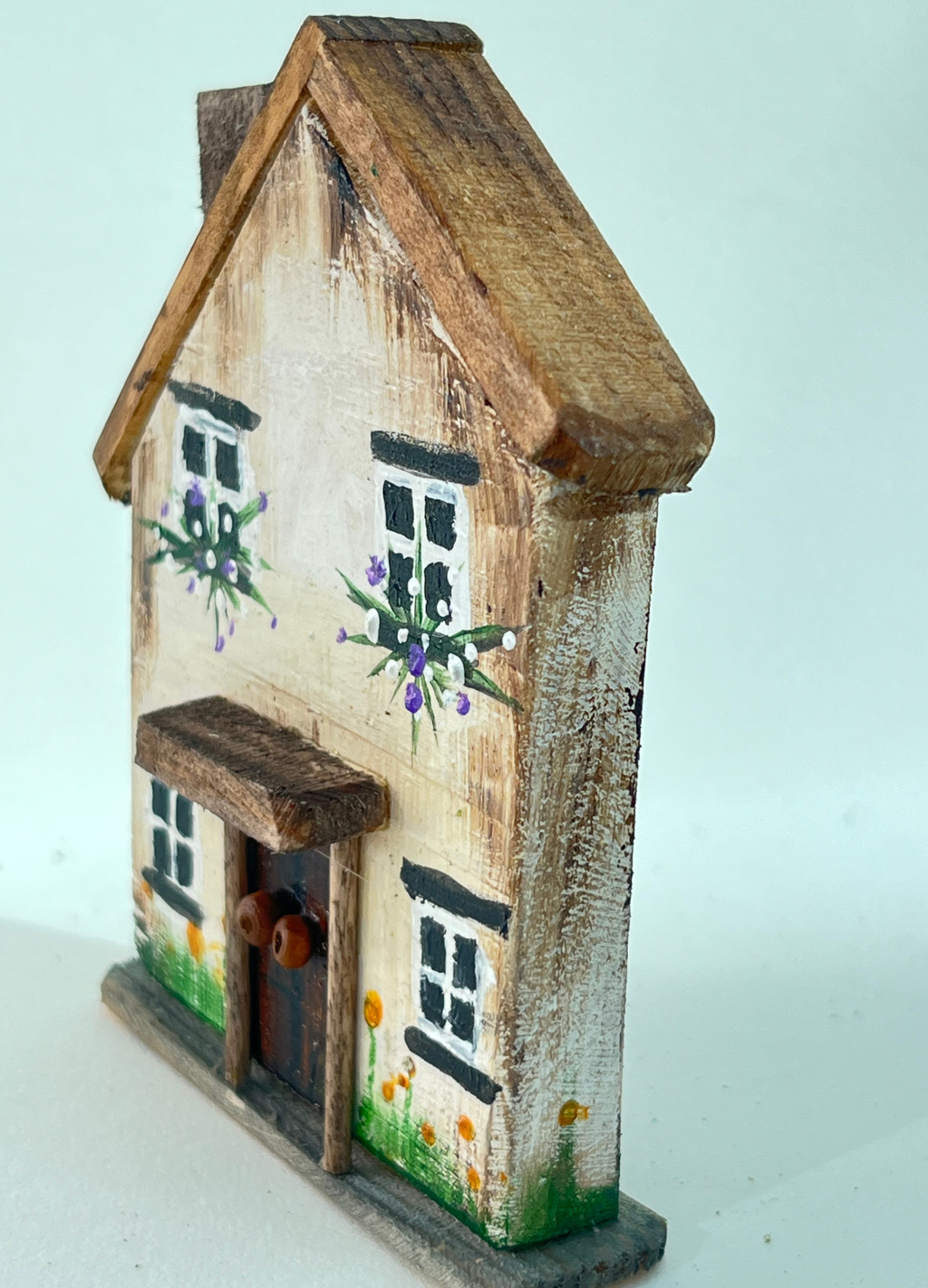 Miniature diorama with a house, and plants on a white background (RRH1050)