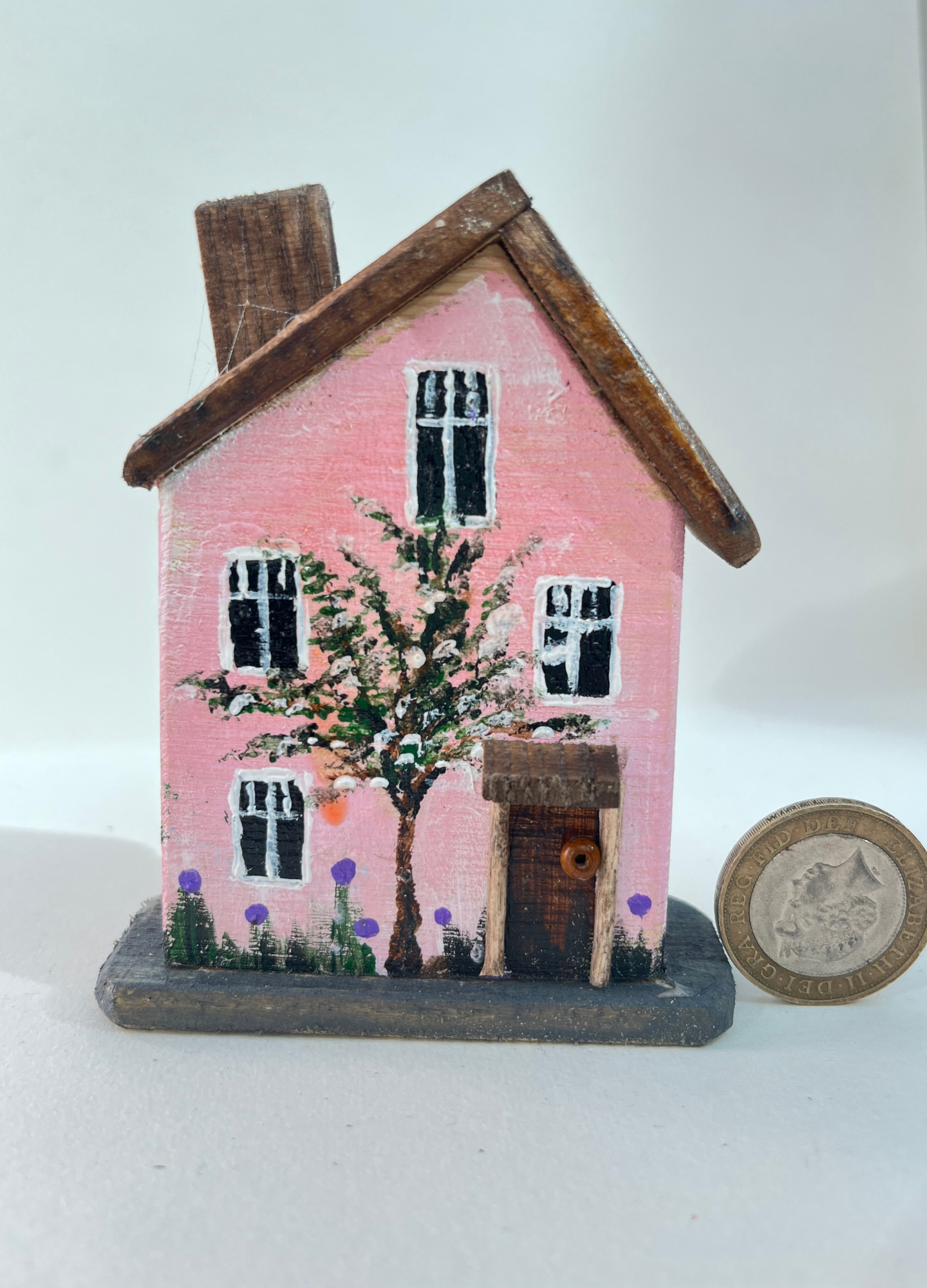 Miniature diorama with a house, and plants on a white background (RRH1052)
