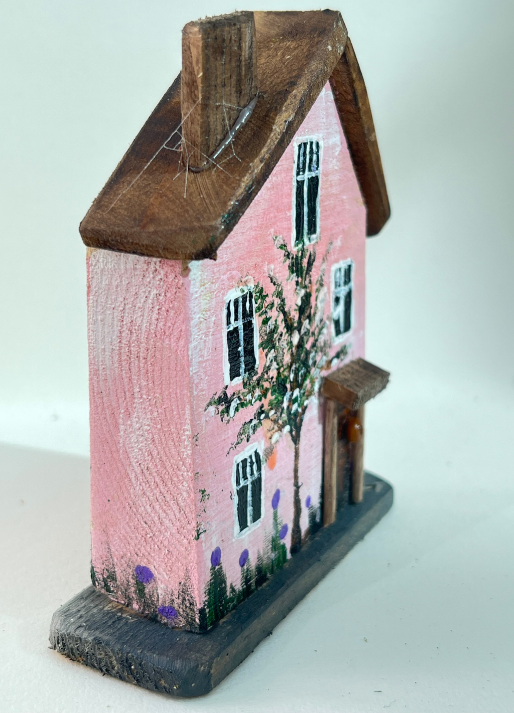 Miniature diorama with a house, and plants on a white background (RRH1052)