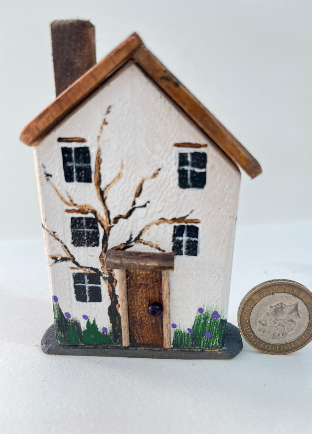 Miniature diorama with a house, and plants on a white background (RRH1053)