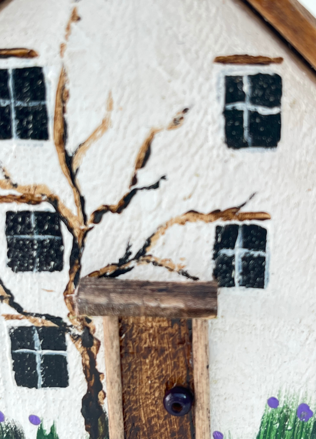 Miniature diorama with a house, and plants on a white background (RRH1053)