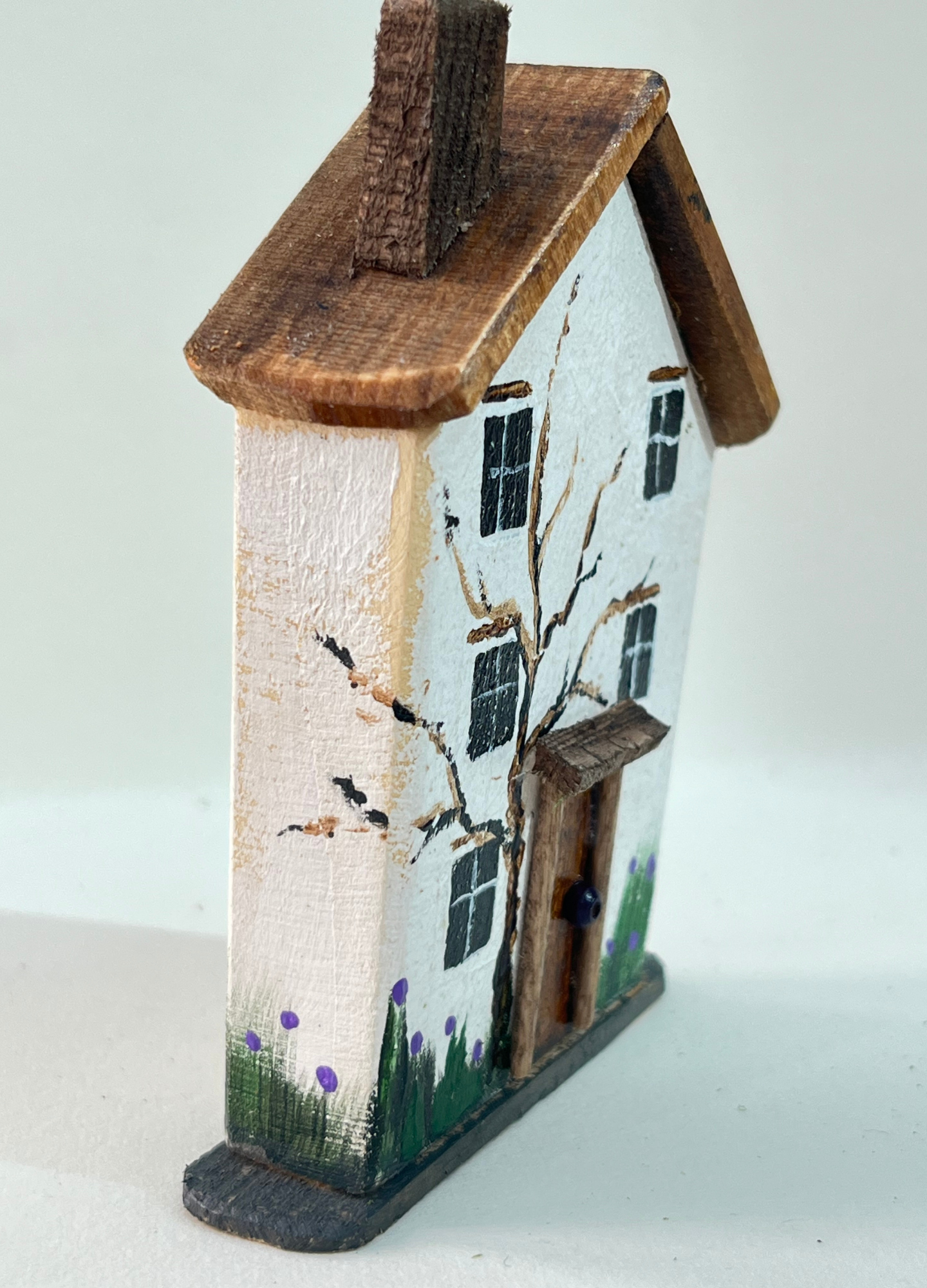 Miniature diorama with a house, and plants on a white background (RRH1053)