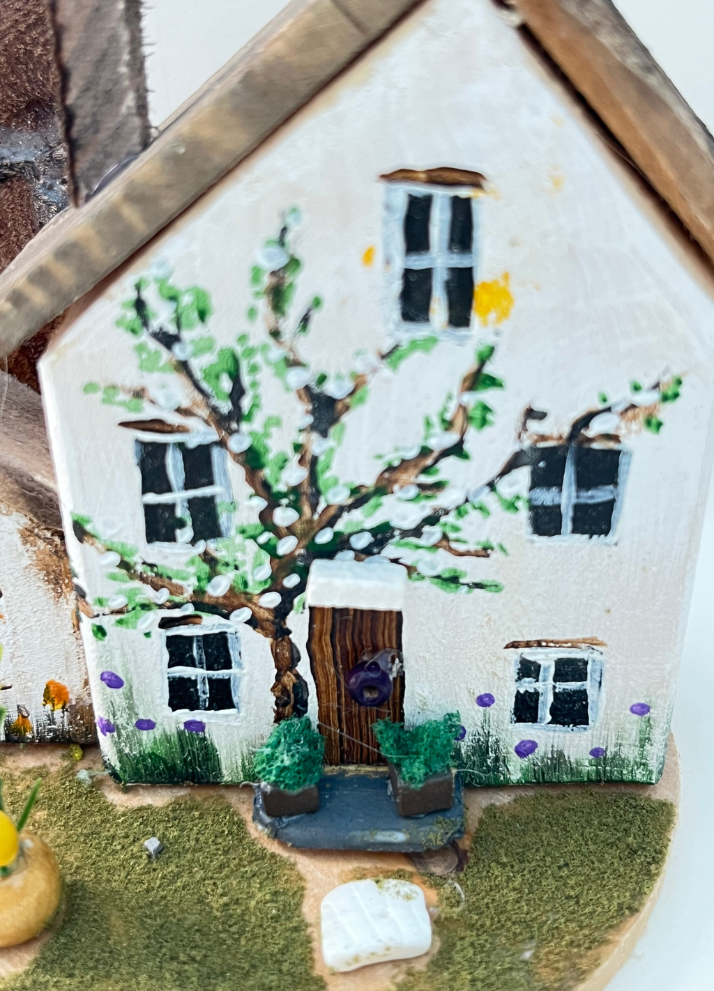 Miniature diorama with a house, and plants on a white background (RRH1043)