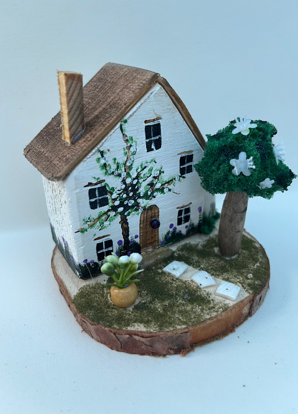 Miniature diorama with a house, and plants on a white background (RRH1041)