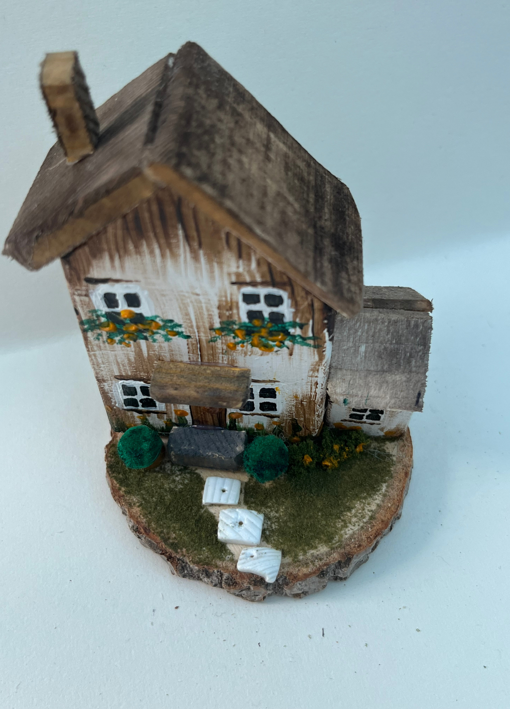 Miniature diorama with a house, and plants on a white background (RRH1045)