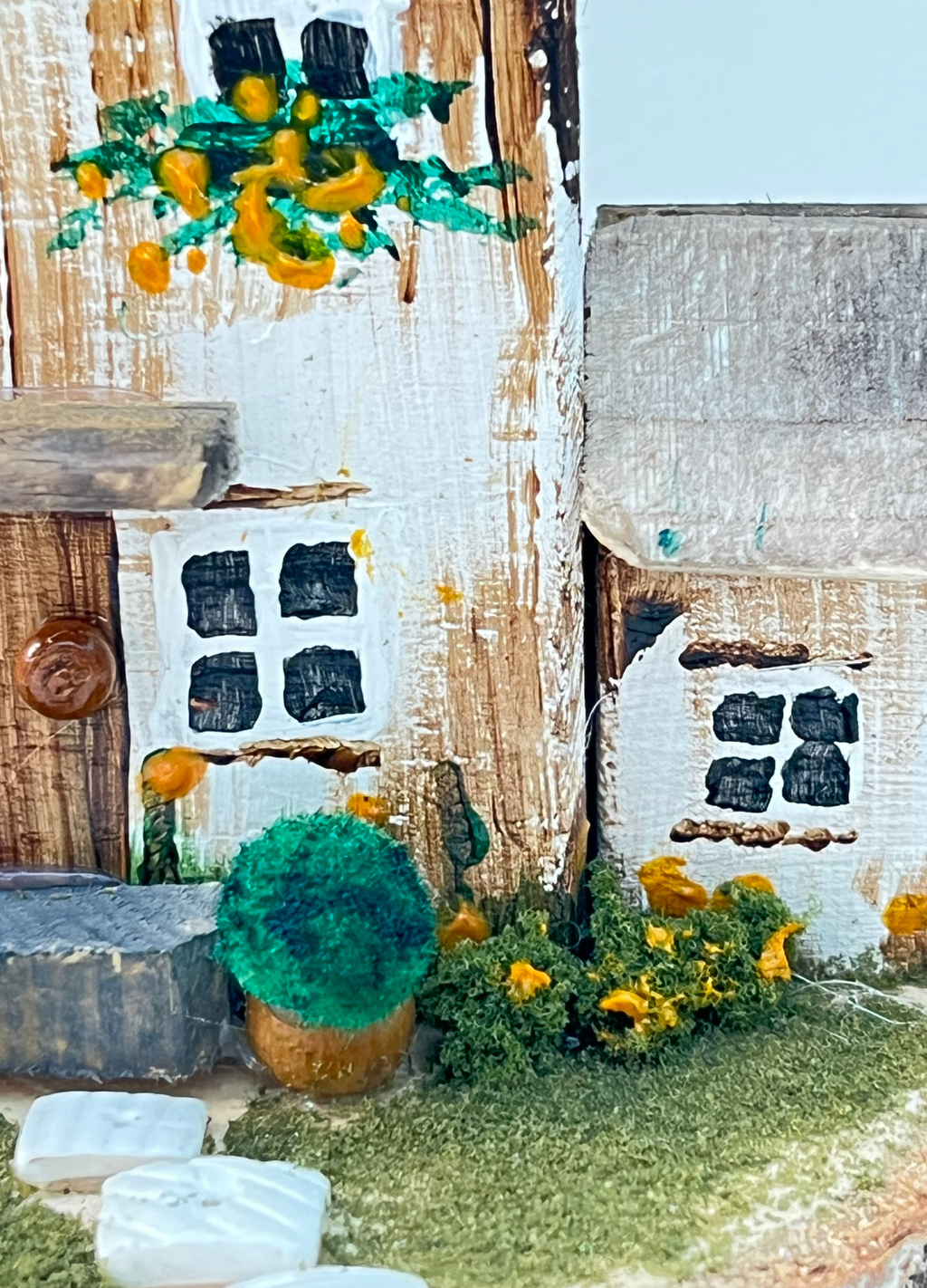 Miniature diorama with a house, and plants on a white background (RRH1045)