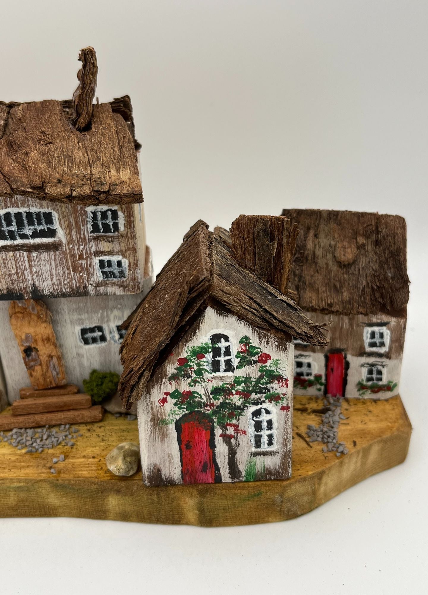 Five Handcrafted Miniature Wooden houses on natural wooden base RRH1028